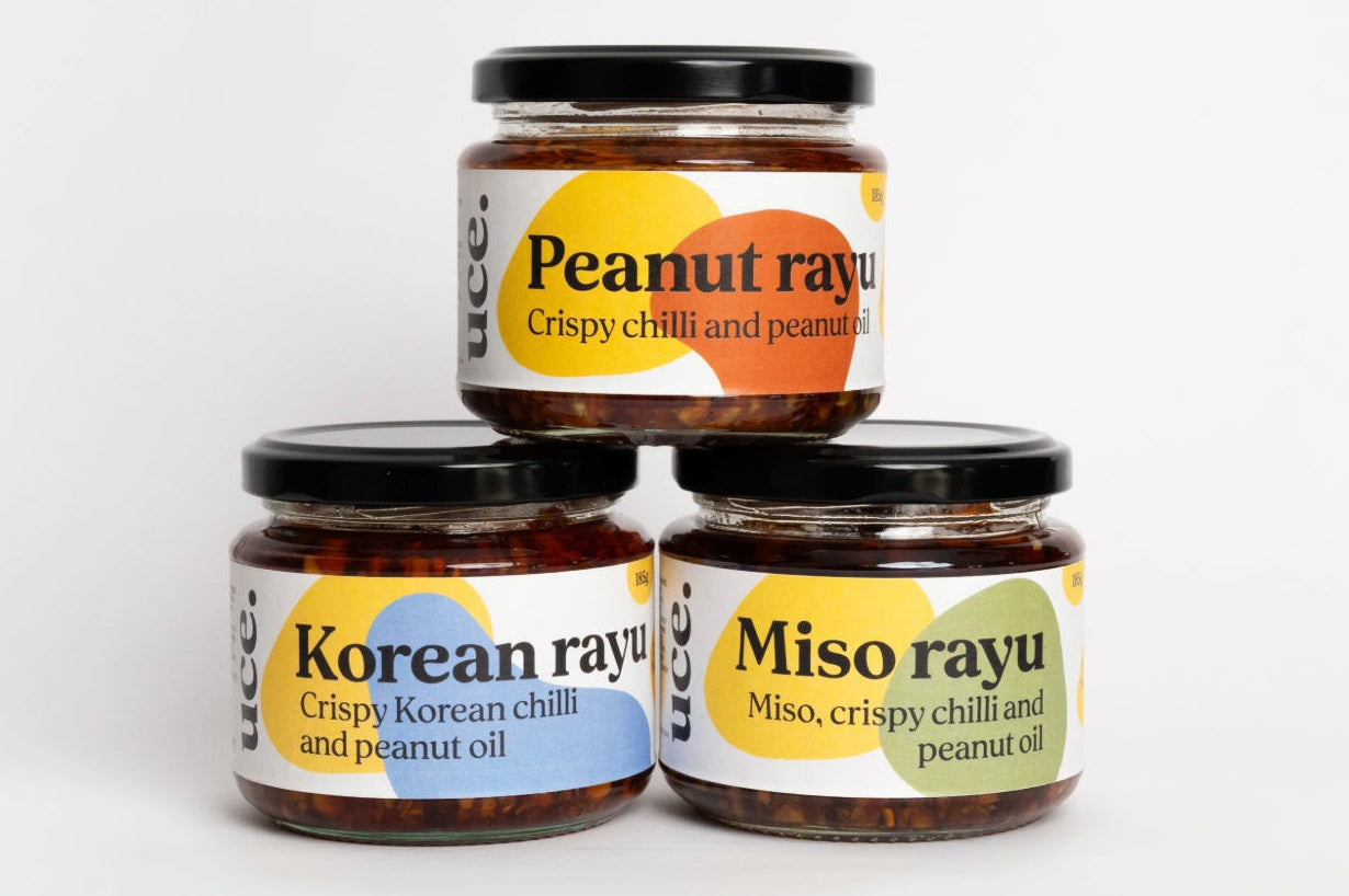 Three jars of rayu sauce with labels on a white background