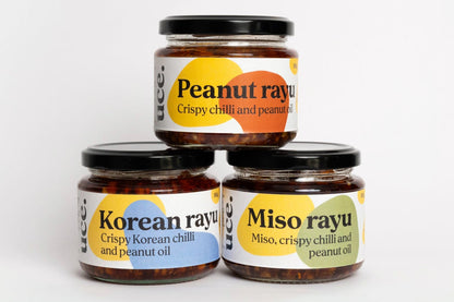 Three jars of rayu sauce with labels on a white background